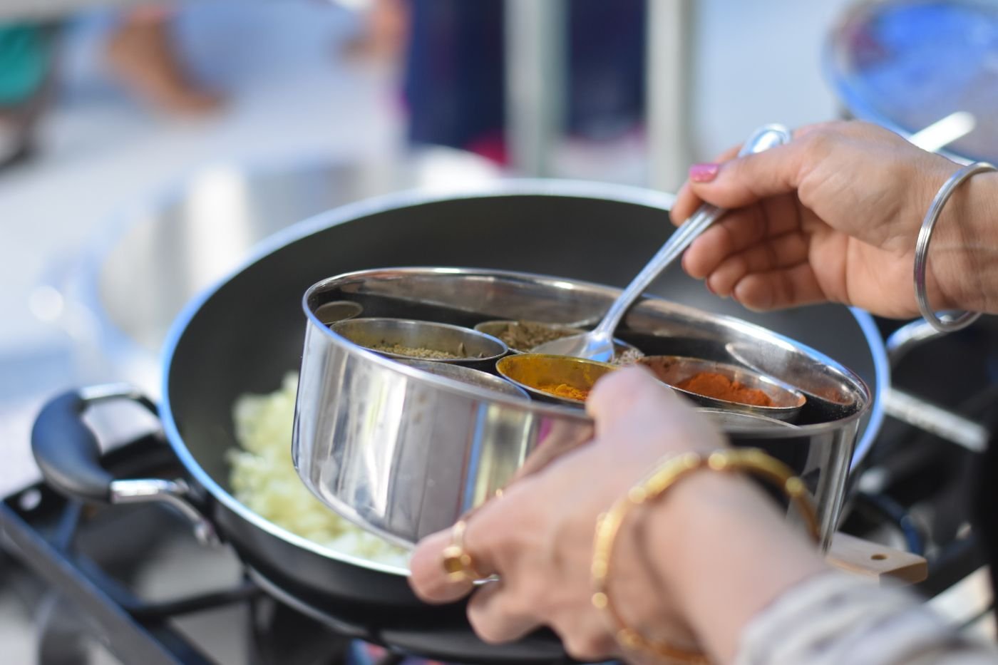 Hands preparing traditional spices