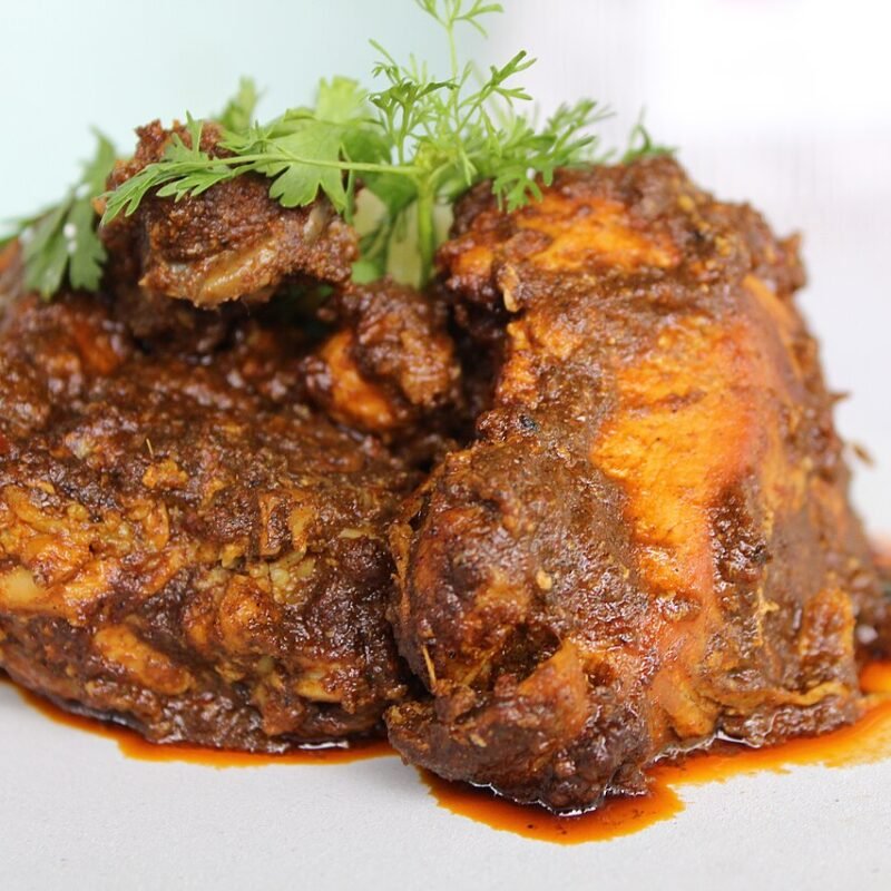 Chicken Chukka - dry-roasted spicy South Indian chicken with dark reddish-brown coating and coriander garnish