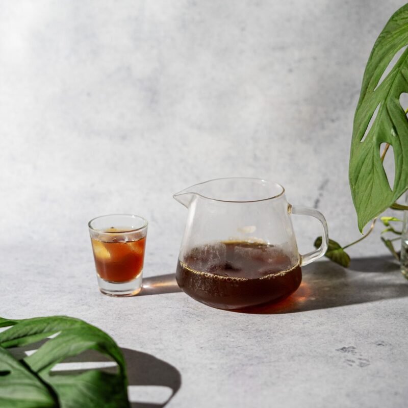 Minimalist iced coffee with monstera leaf