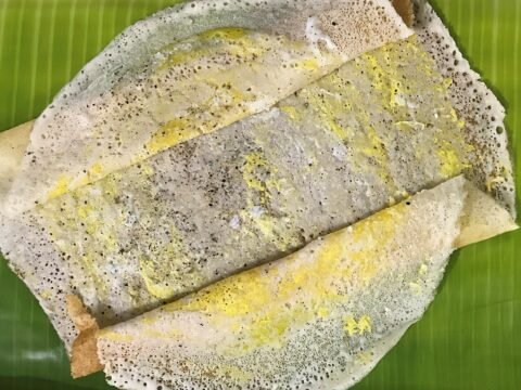 Dosa topped with a layer of spiced egg