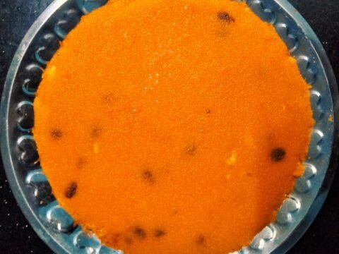 Bright orange South Indian rava kesari with raisins
