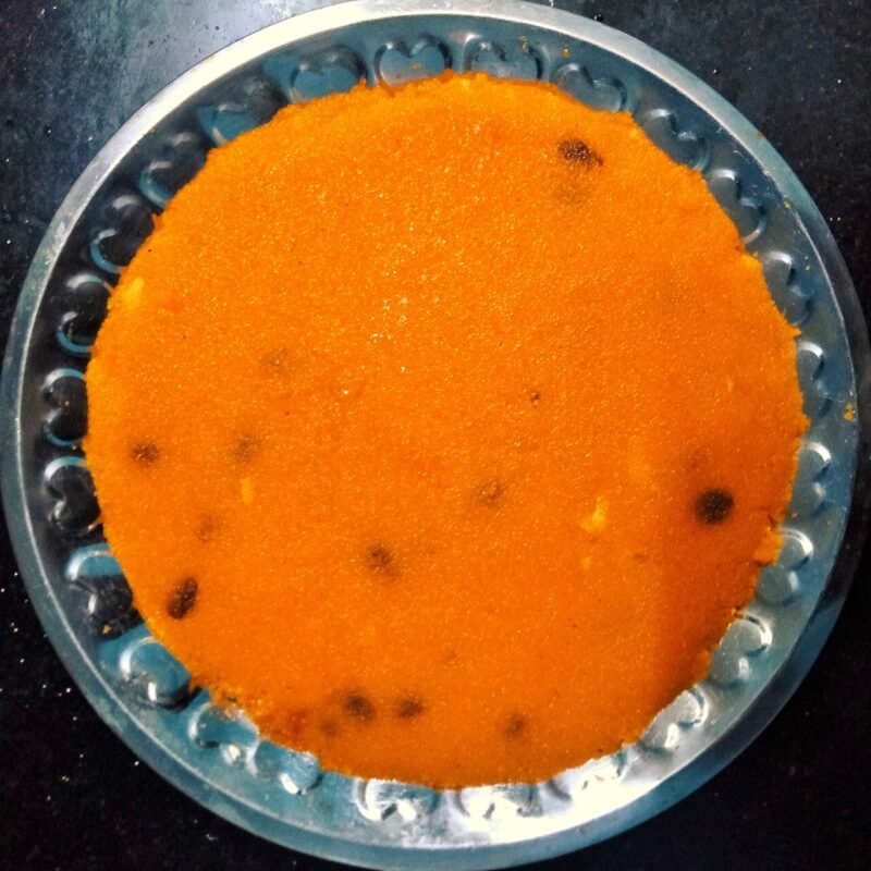 Bright orange South Indian rava kesari with raisins