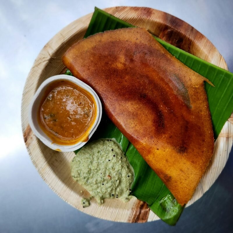 Masala dosa with chutney on banana leaf
