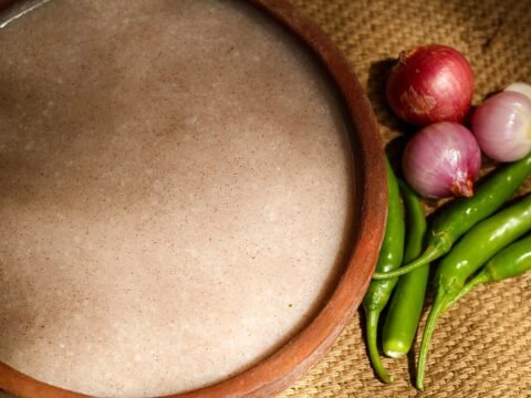 Fermented ragi porridge served with shallots, garlic and green chilies