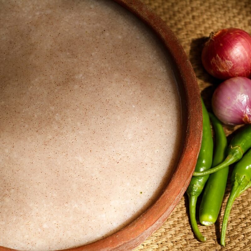 Fermented ragi porridge served with shallots, garlic and green chilies