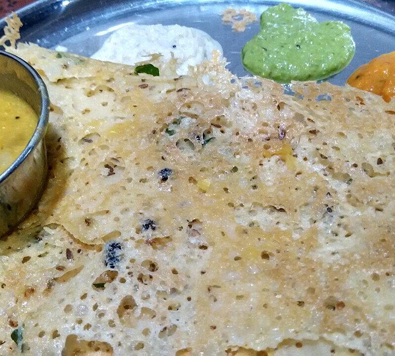 Crispy lacy-textured rava dosa with sambar and chutneys