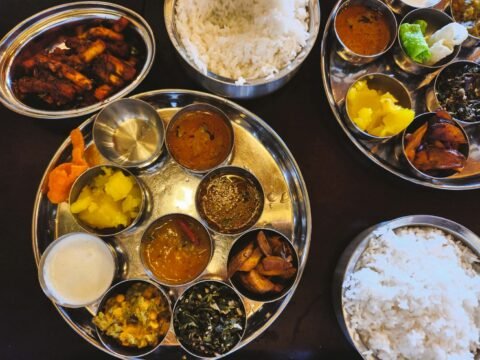 Traditional Indian thali with rice and side dishes