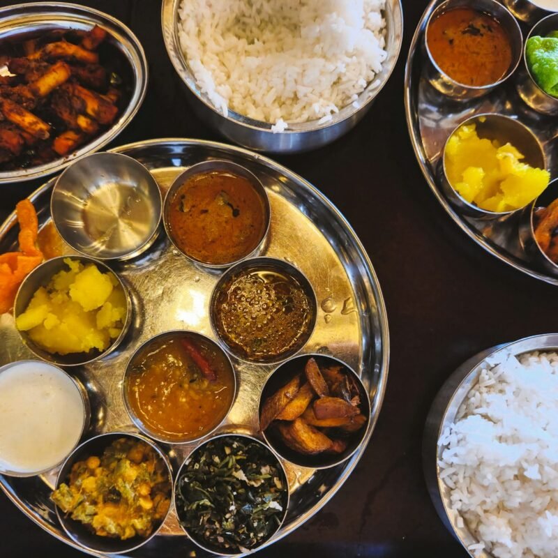 Traditional Indian thali with rice and side dishes
